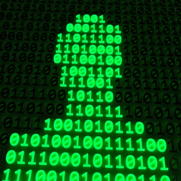 Green silhouette of a person made up of 0 and 1